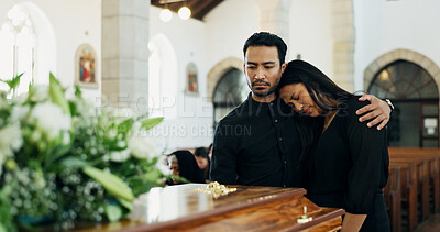 Buy stock photo Couple, coffin and embrace at funeral for death, pay respect or comfort for loss in christian church. Sad man, woman and grief at memorial service with casket to mourn, hug or console for depression