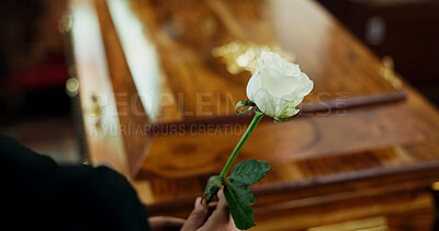 Buy stock photo Hands, person and rose with casket at funeral for farewell, mourning death and goodbye at burial ceremony. Sad, widow and rip with flowers for coffin respect, memorial service and emotional for loss