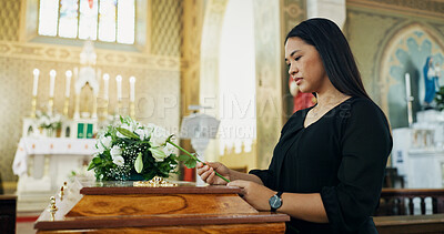 Buy stock photo Sad, woman and rose at funeral for farewell, mourning death and goodbye at burial ceremony. Female person, flower and coffin with respect for rip, memorial service and emotional for loss at church