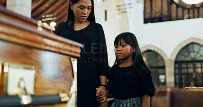 Buy stock photo Death, sad and mom with child in funeral holding hands for farewell, mourning loss or grief. Respect, goodbye or people with casket or family in Christian cathedral for burial, support or memorial