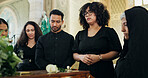 Sad, people or family with casket in funeral for farewell service, mourning death or grief. Church, goodbye or respect with coffin or flowers in Christian cathedral for burial, support or memorial