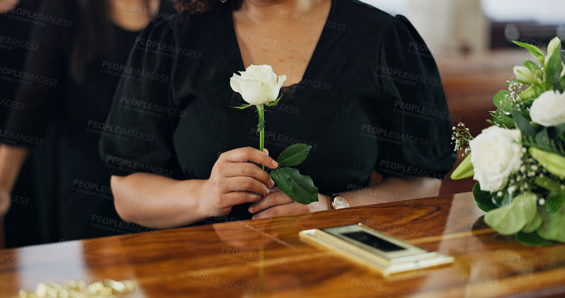Buy stock photo Hands, woman and rose at funeral for farewell service, mourning death and goodbye at burial ceremony. Person, family and respect with rip, memorial comfort and emotional gathering at community church