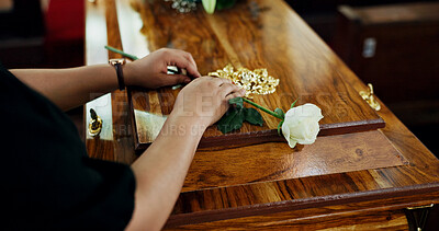 Buy stock photo Hands, person and flower on coffin at funeral for farewell, mourning death and goodbye at burial ceremony. Sad, widow and rip with rose for casket respect, memorial service and emotional for loss