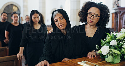 Buy stock photo Sad, women and coffin at funeral for farewell service, mourning death and goodbye at burial ceremony. People, family and respect with rip, memorial comfort and emotional gathering at community church