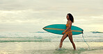Girl, surfboard and smile at beach with walk for water sports, hobby and outdoor in morning on holiday. Woman, surfer and happy for training, fitness and space in sky, waves and ocean in Costa Rica