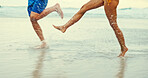 Legs, splash and water with people at beach for playful, summer vacation and adventure. Travel holiday, bonding and freedom with closeup of feet of friends outdoors for social, seaside and care