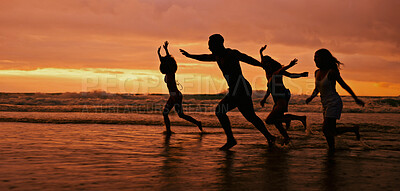 Buy stock photo Silhouette, running and people on beach for sunset, freedom and excited on summer vacation. Friends, energy and playing at ocean space for travel holiday, adventure and splashing in water for fun
