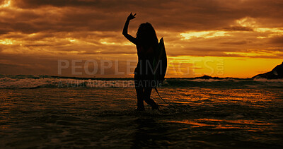 Buy stock photo Silhouette, sign and person with surfboard, beach and journey for surfer on holiday, sunset and sea. Ocean, adventure and woman with gesture for fitness, hobby and sports in nature on summer vacation
