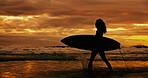 Silhouette, travel and person with surfboard, beach and journey for surfer on holiday, sunset or sea. Summer vacation, adventure and woman with fitness for sport, evening and hobby in nature or ocean