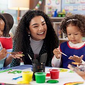 Education, kids and teacher painting hands for art, creative talent and ...