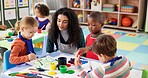 Classroom, teacher and children with painting for education, creativity and skills development. Preschool, educator and kids as students for artwork, learning and growth activity in kindergarten