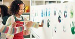 School, painting and children with handprint on paper for creative lesson, education and development. Classroom, students and kids with colors for fun activity, artistic project and motor skills