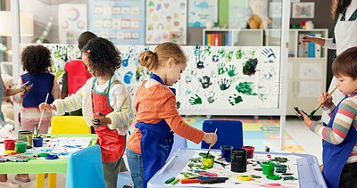 Buy stock photo Handprint, painting and kids with paper in classroom for creative lesson, education and development. School, students and children learning with colors for fun activity, art project and motor skills