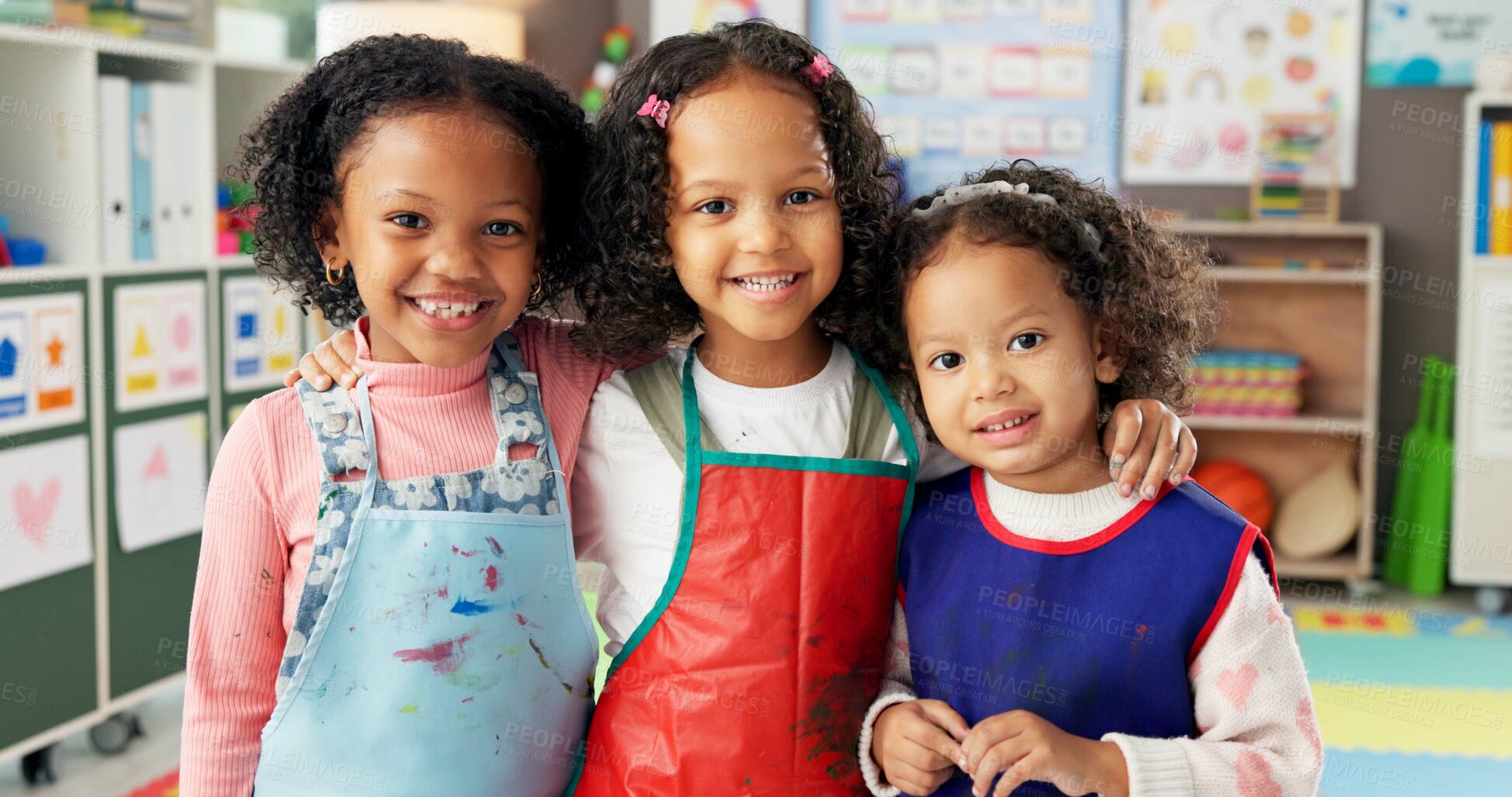Buy stock photo Happy girls, portrait and kindergarten with hug for friendship, education or fun learning together. Face, kids or children with smile or apron for creativity, art and crafts in elementary classroom