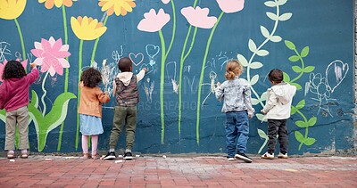 Buy stock photo Wall, children and writing with chalk for education, cognitive development and creativity in school. Back, students and kids with learning for drawing mural, inspiration and outdoor in kindergarten