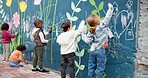Wall, children and drawing with chalk for creativity, growth development and education in school. Back, students and kids with learning for writing mural, inspiration and outdoor in kindergarten