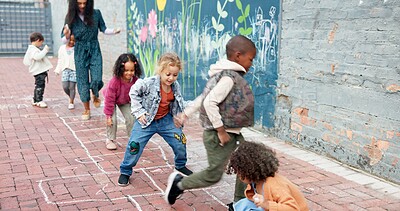 Buy stock photo Hopscotch, kids and playing with outdoor game at Kindergarten for childhood development. Group, children or learners jumping with teacher for fun activity, hopping or skipping on school playground