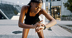 Runner, tired and smart watch with black woman in city for fitness app, tracking progress and heart rate. Wellness, training and speed challenge with person and time for exercise, sports and cardio
