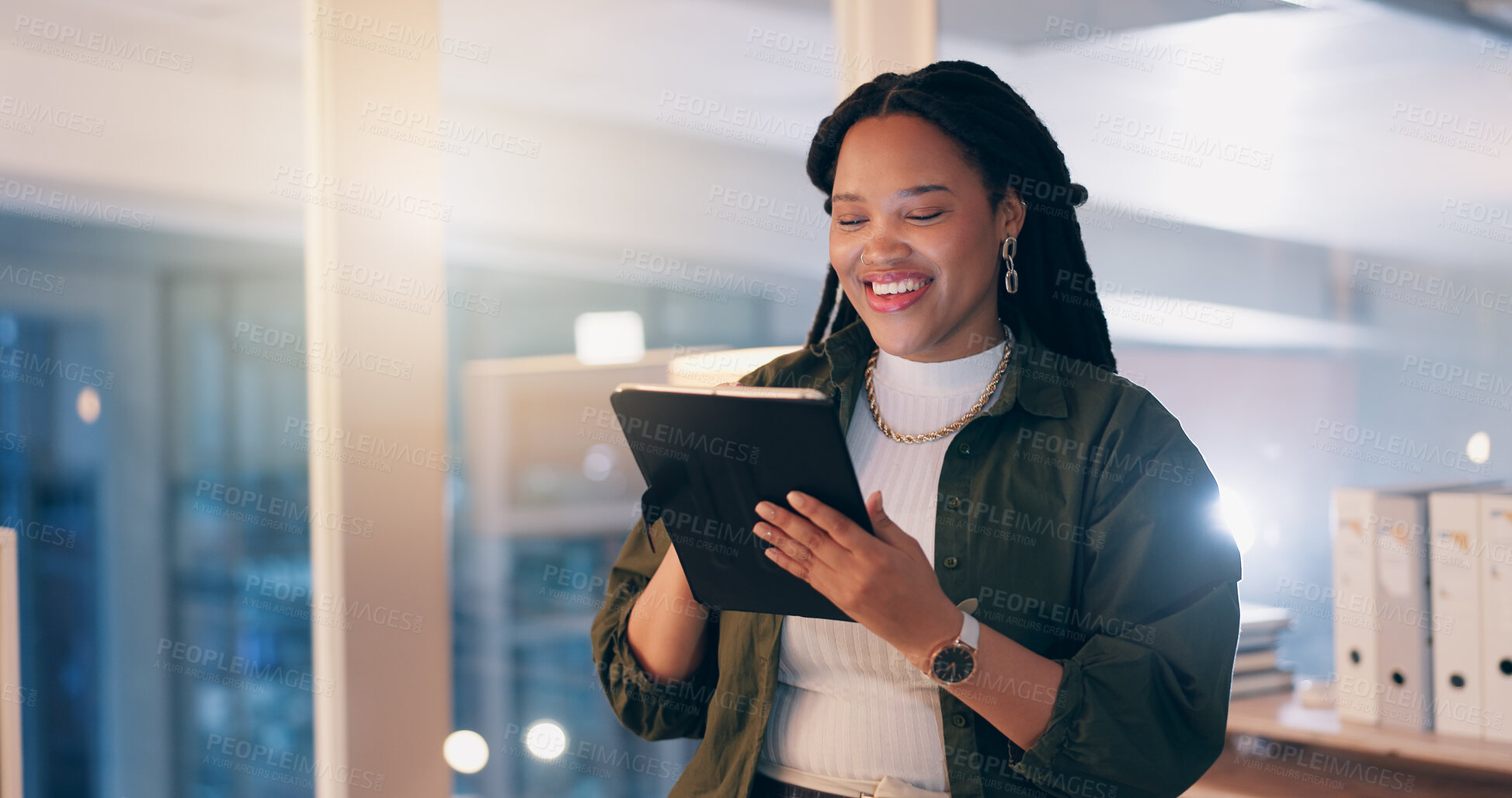 Buy stock photo Black woman, tablet and happy at office, night and reading notification with overtime at media company. Person, journalist or writer on digital touchscreen, app and smile for editing story at agency