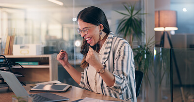 Buy stock photo Woman, fist and success with laptop at office, night and celebration for goals, winning or promotion at startup. Person, writer and happy with cheers, bonus or approval for project at creative agency