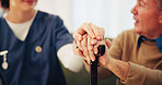Senior man, cane and holding hands with nurse for support, health or help in retirement home. Caregiver, comfort and person with disability with walking stick for medical assistance, empathy or trust