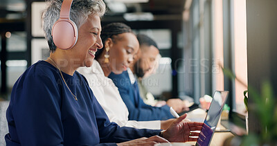 Buy stock photo Business, headphones and woman on laptop at coworking space for video call, online meeting and website. Mature person, smile and tech for webinar, listening to music and editing story of publication