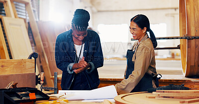 Buy stock photo Conversation, women and woodworker with customer in workshop for furniture planning with blueprint. Industry, talk and artisan with client for product manufacturing with timber material in warehouse
