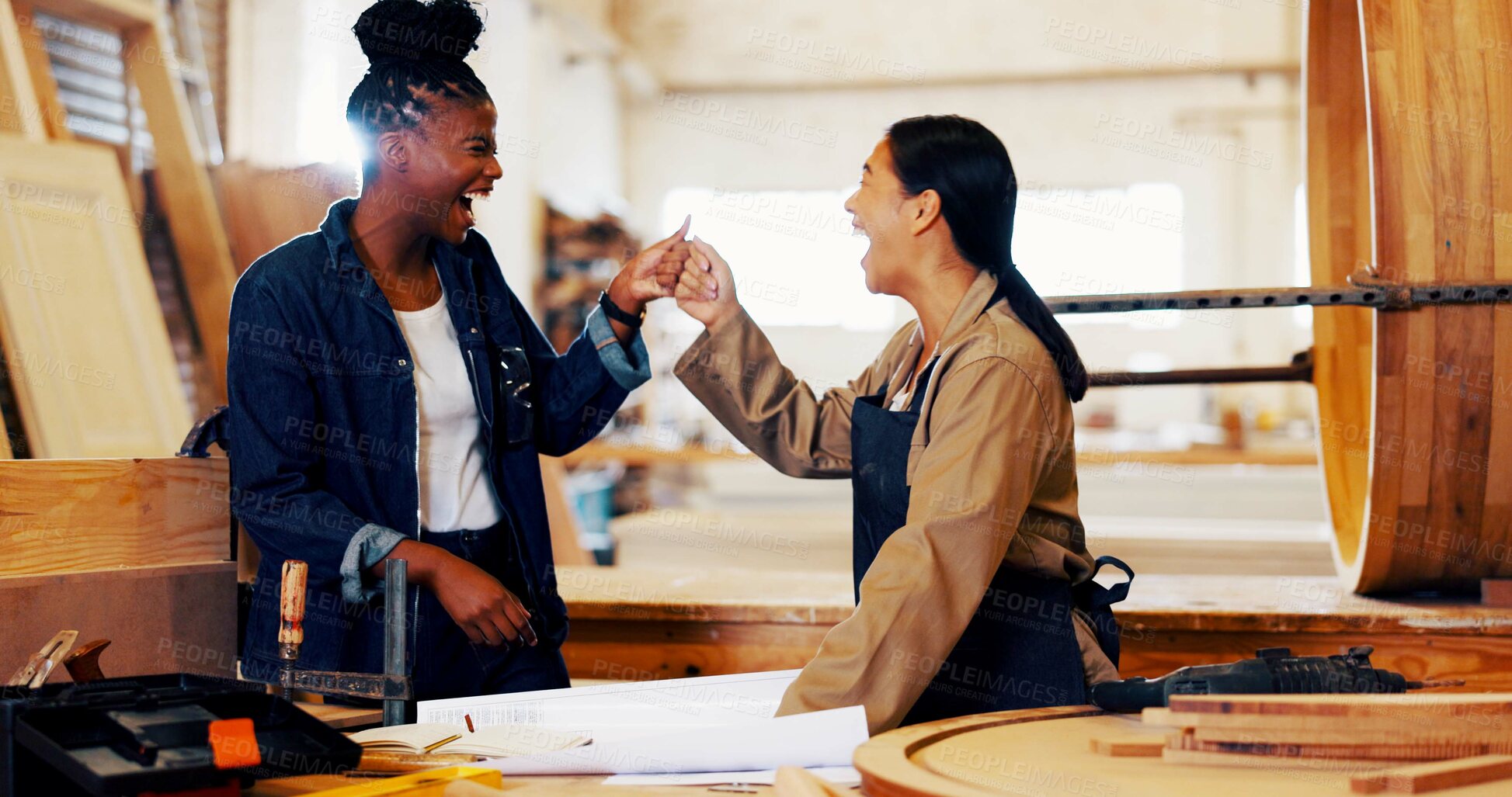 Buy stock photo Fist bump, women and carpenter with teamwork in workshop for furniture, process or manufacturing. Happy, partnership and female woodworker with client in warehouse for timber material production.