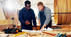 Men, together and blueprint with wood at factory, talk or review with mentor, training or construction material. People, floor plan and coach for timber, feedback or equipment at industrial warehouse