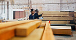 Man, woman and checklist at factory with wood, point and inventory inspection with team at plant. Black people, talk and clipboard for quality assurance, industry and advice with manufacturing job