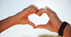 People, shape and love with heart hands or sunshine in nature for romance, outdoor date or valentines day. Closeup, couple or icon with symbol for romantic gesture, kindness or thank you together