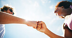 Woman, man and fist bump for fitness, outdoor and low angle with achievement, goals and training with sky. People, team and support with workout for marathon, respect and motivation for exercise