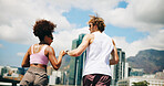 Woman, man and fist bump with running, outdoor and back with achievement, goals and training in city for summer. People, team and support with workout for marathon, greeting and motivation in town