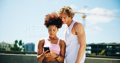 Buy stock photo Woman, man and phone for fitness, city and happy with search for direction, location and training on bridge. Interracial couple, runner and smartphone on timer app, workout and check stats in street