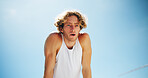 Breathing, fitness and recovery with man on blue sky outdoor for break, challenge or fatigue. Exercise, sweat and tired with athlete or runner resting from below for training or workout routine