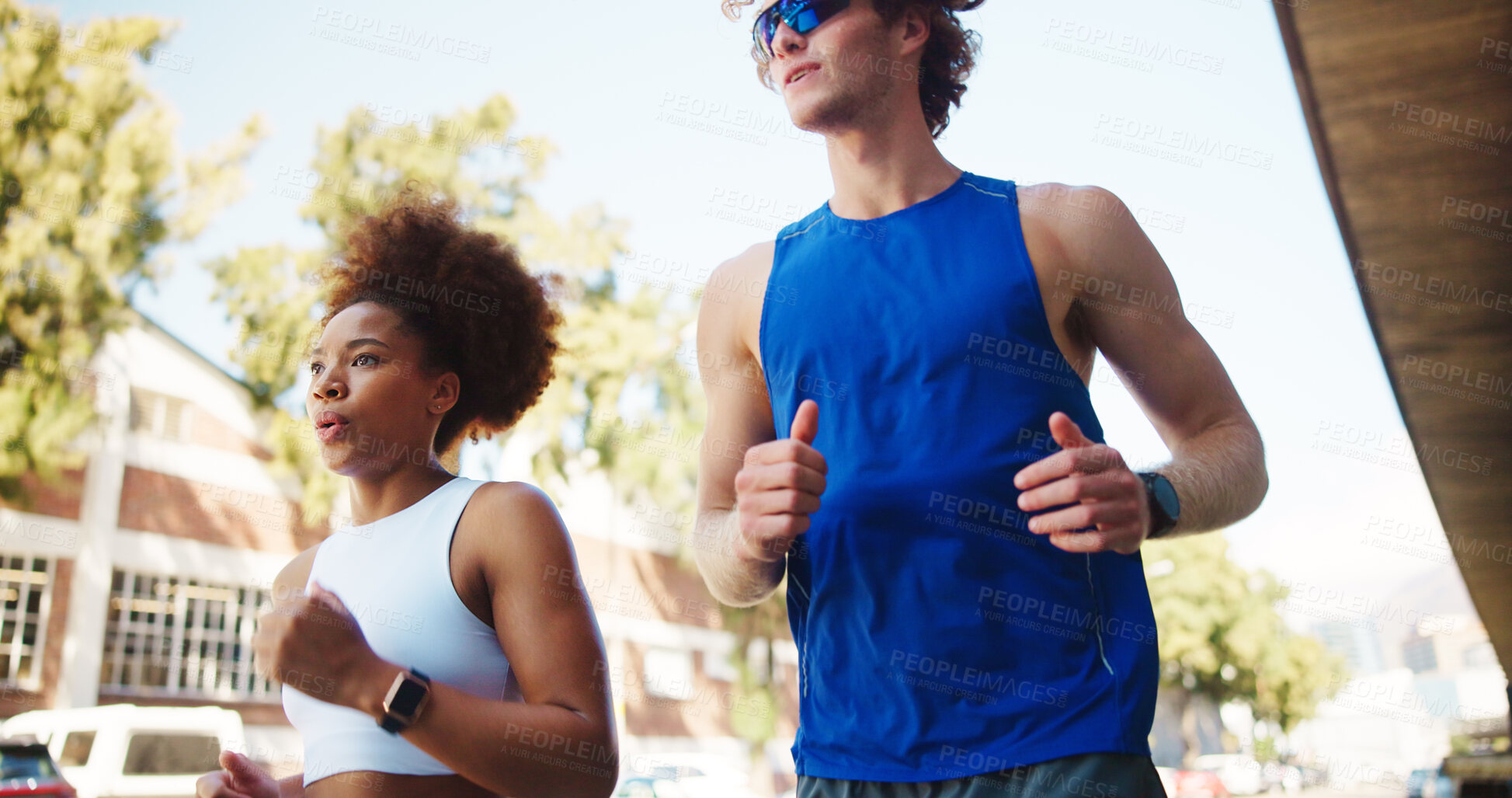 Buy stock photo Couple, fitness and running for workout in city, cardio together with exercise and wellness. Interracial people, marathon training or sports challenge with team, urban and athlete partners outdoor