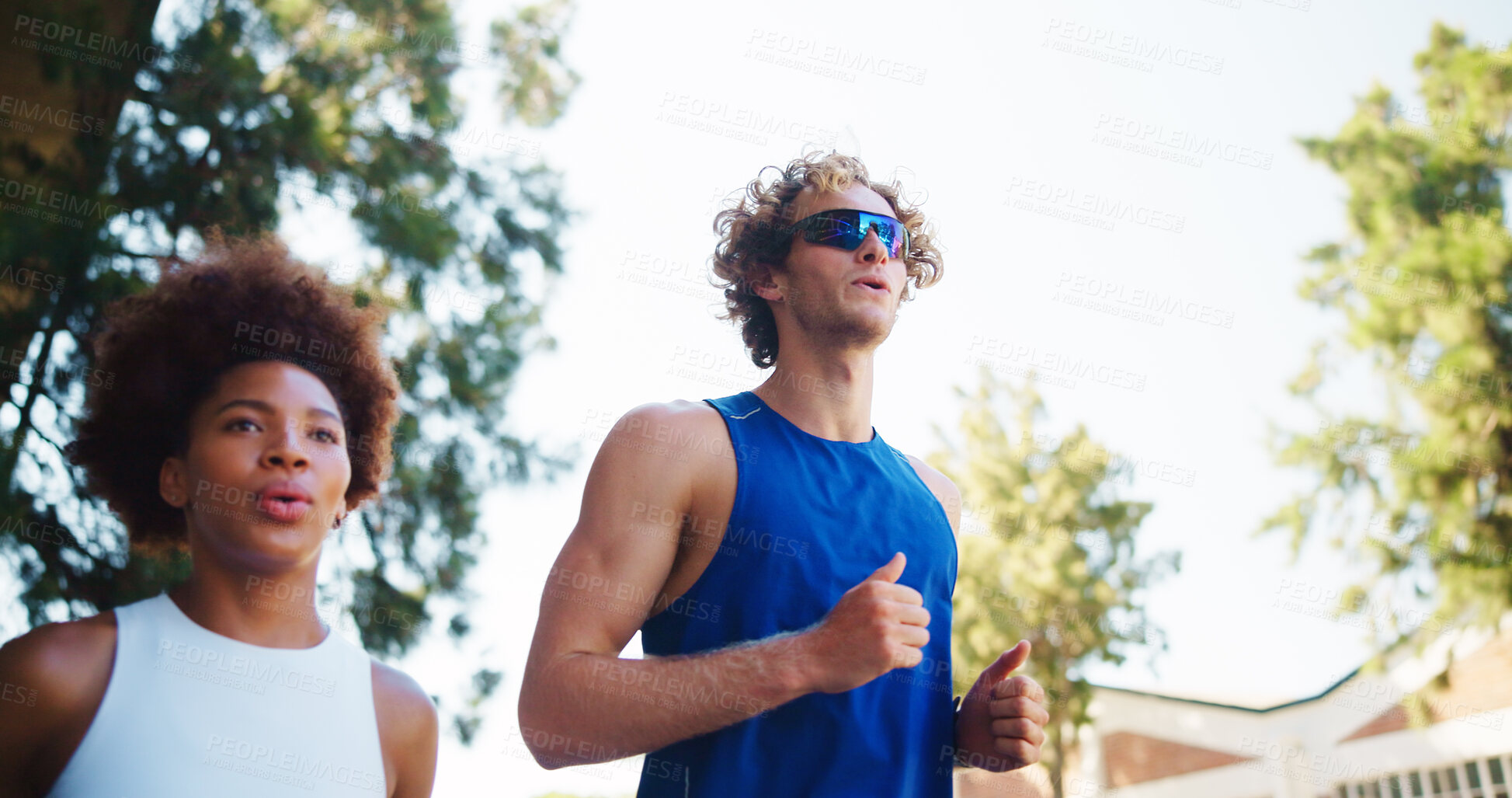 Buy stock photo Couple, fitness and run for workout in city, cardio together with exercise and wellness. Below interracial people, marathon training or sports challenge with team, urban and athlete partners outdoor