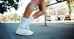 Sneakers, athlete and person in street stretching for fitness warm up, start exercise and ready for run outdoor. Cardio, health and wellness with shoes for workout, begin training and legs in city