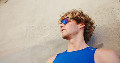 Buy stock photo Thinking, wall and runner or man with glasses in city for workout, marathon training and resting. Reflection, exercise and wellness with male person downtown for fitness cardio, athlete and space