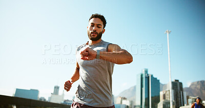Buy stock photo Man, fitness and running with watch in city for workout app, exercise or tracking performance. Active, male person or runner checking wristwatch for steps, calories or monitoring heart rate in town