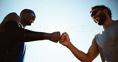 Buy stock photo Fitness, people and fist bump in city for support, team achievement and wellness goal. Low angle, personal trainer and man outdoor with hand gesture, exercise collaboration and commitment in session