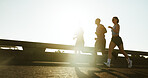 People, running or fitness with sunshine in city for workout, exercise or training on road. Active group, friends or runners with bridge for sport marathon or outdoor sprint together in an urban town
