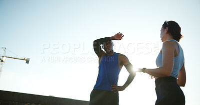 Buy stock photo Fitness, people or sweat with blue sky for workout, exercise or intense outdoor training. Active man, woman or low angle with lens flare or space for physical activity, health or wellness in town