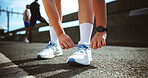 Fitness, hands and tie shoes in city to start workout, training or exercise for practice on road. Street, person and runner tying laces on sneakers for sports, preparation and ready for challenge