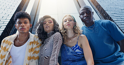 Buy stock photo Below, fashion and portrait of friends in city with confidence for style, trendy clothes and outfit. Low angle, gen z and men and women in urban town for perspective, aesthetic and photography