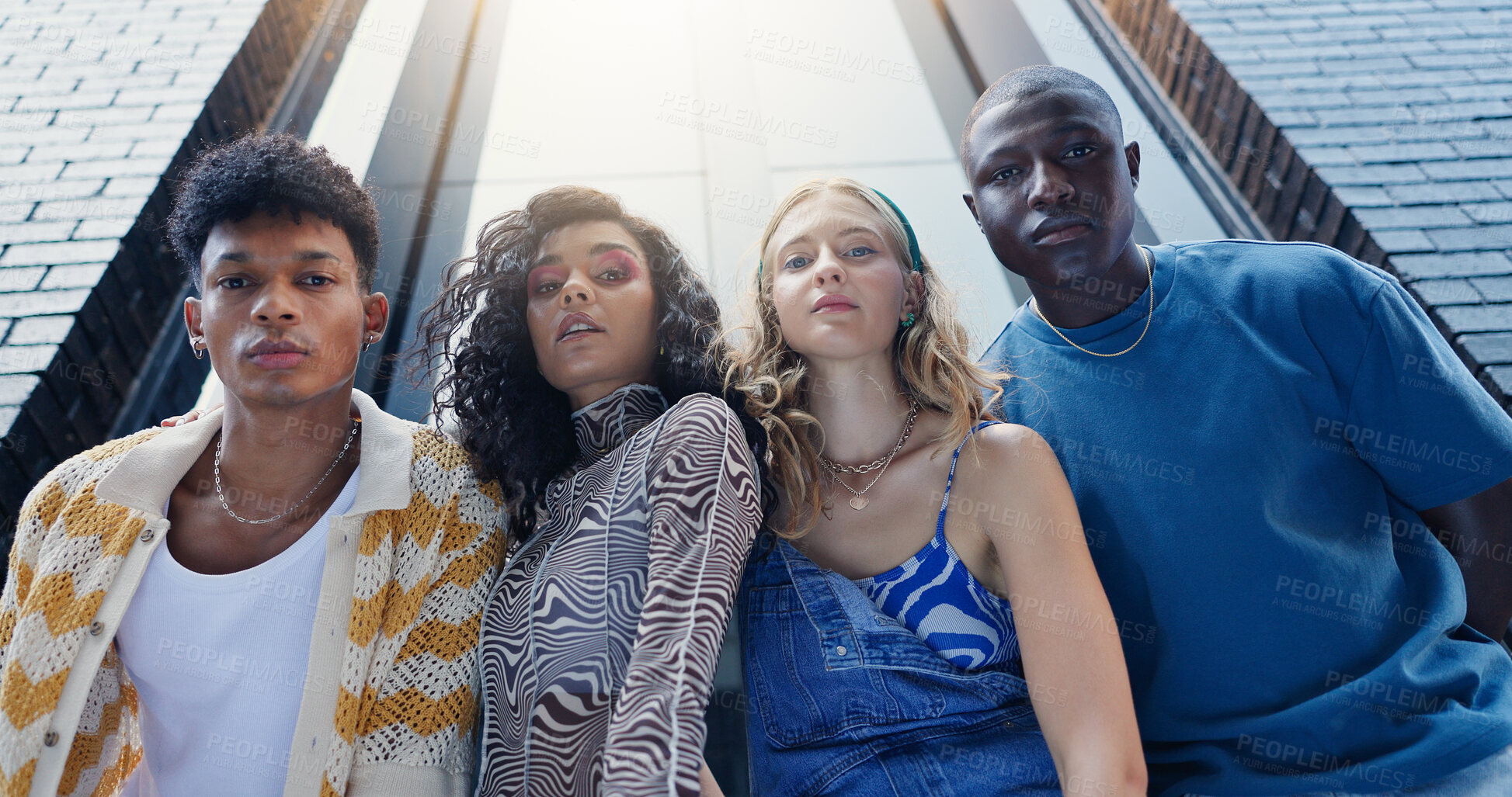 Buy stock photo Below, fashion and portrait of friends in city with confidence for style, trendy clothes and outfit. Low angle, gen z and men and women in urban town for perspective, aesthetic and photography
