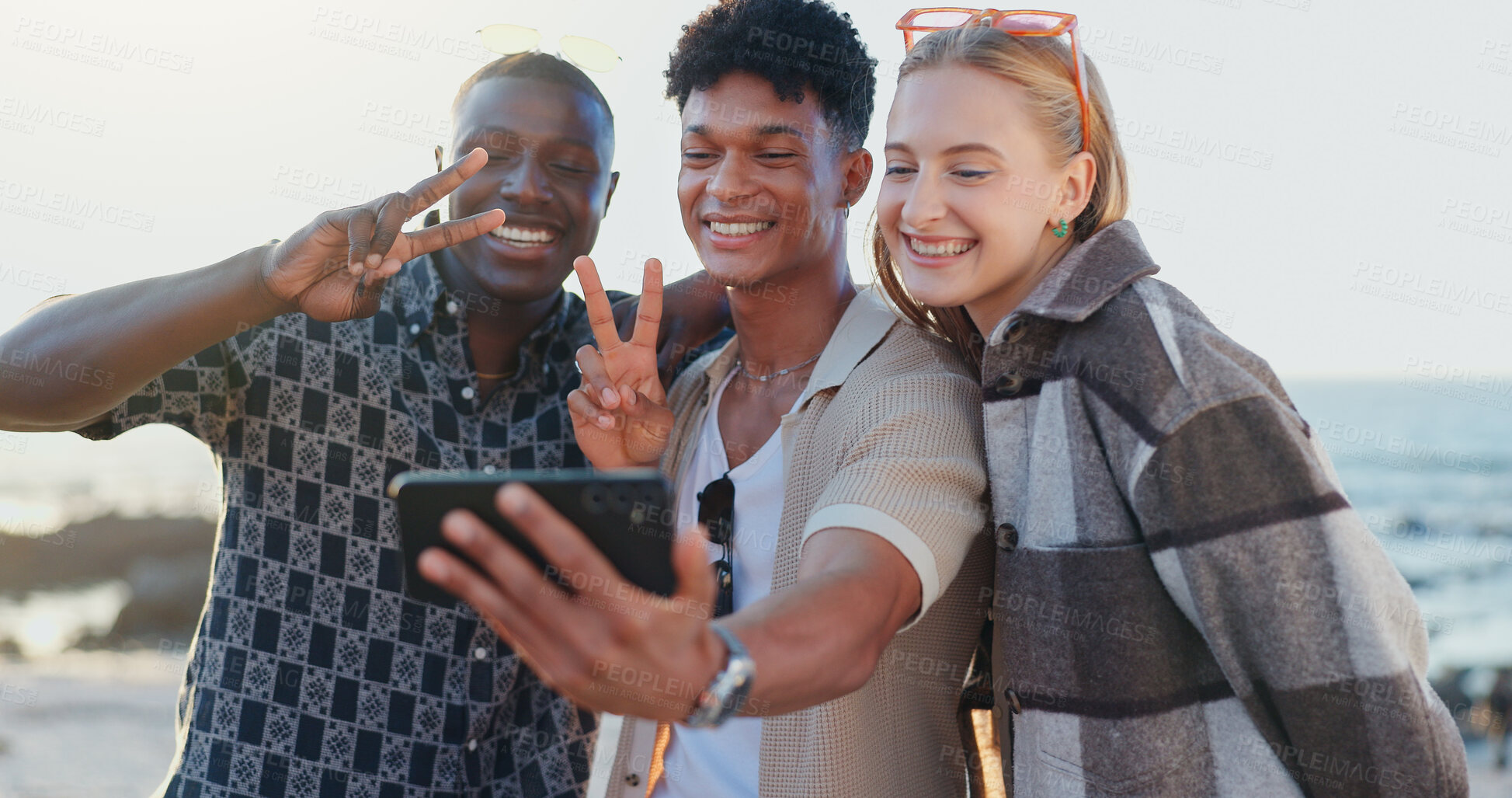 Buy stock photo Friends, people and selfie with peace sign at beach for social media post, travel memory or profile picture update. Happy, group and photography on holiday adventure with bonding, support or vacation