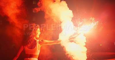 Buy stock photo Excited, night and woman in celebration with fireworks for outdoor party, New Year or social event. Burn, holiday vacation and happy female person with fire art, smoke and flare for sparkle lights