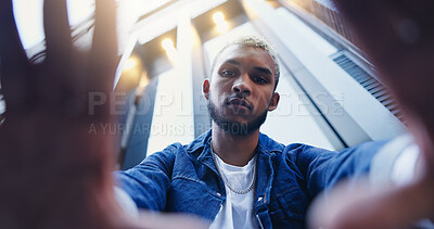 Buy stock photo Low angle, frame and portrait of man in city with confidence for style, trendy and outfit. Below, perspective and selfie of person in urban town for fashion, aesthetic and picture for photography