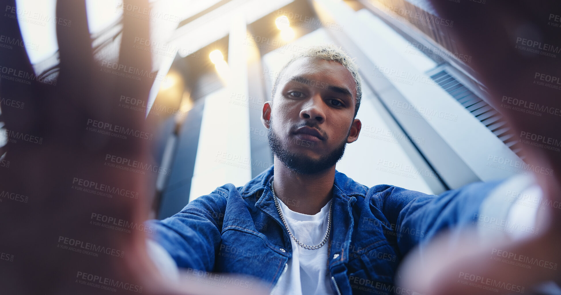 Buy stock photo Low angle, frame and portrait of man in city with confidence for style, trendy and outfit. Below, perspective and selfie of person in urban town for fashion, aesthetic and picture for photography